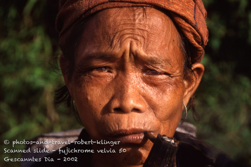 A vietnamese woman smoking a pipe
