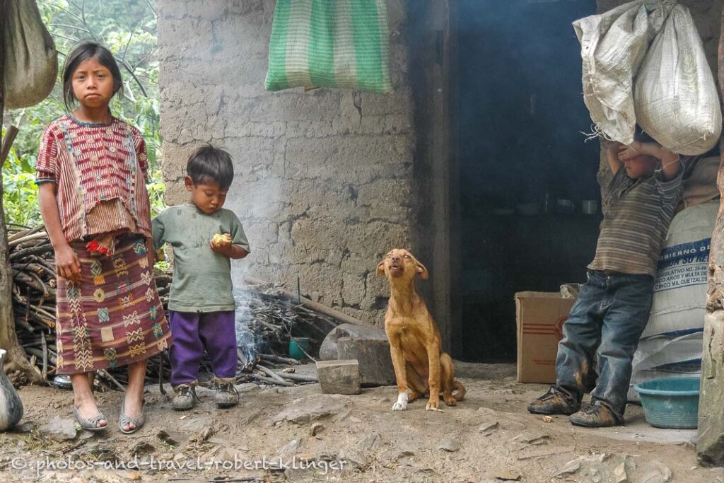 3 kids in front of their house in Guatemala