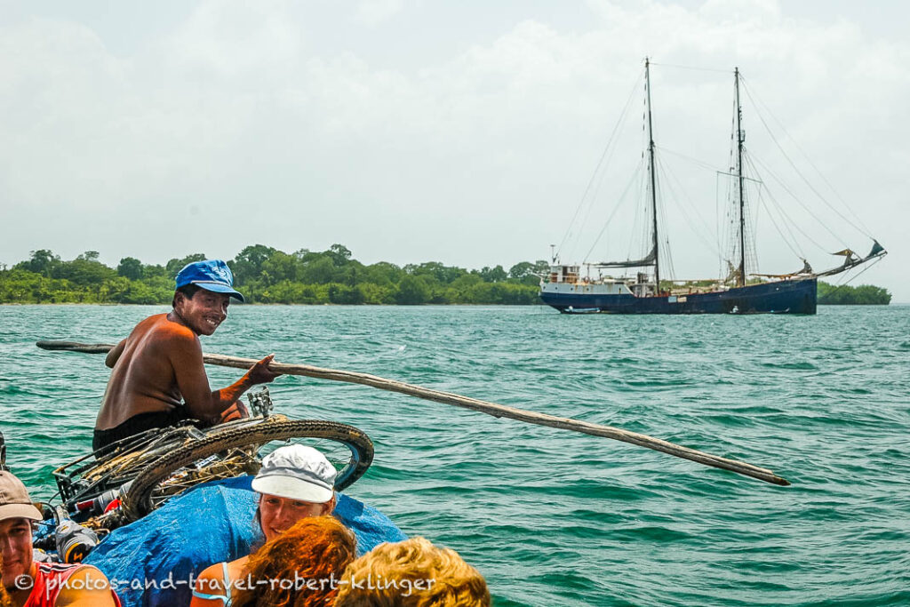 young traveller arriving by canoe at the sailing ship stahlratte