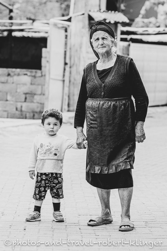An albanian grandmother and her grandson, Donkeys are used for transportation in Albania
