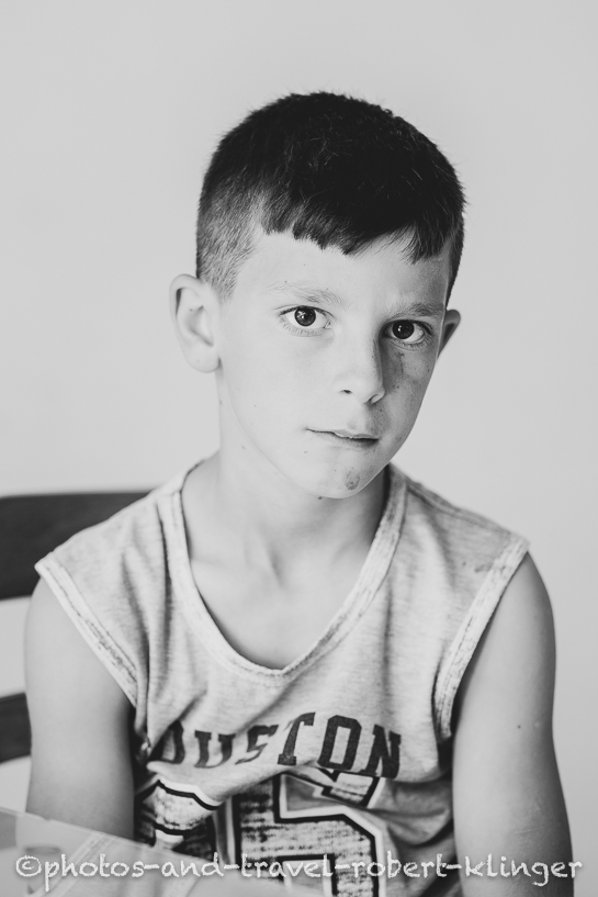 A boy in Albania, A vendor in his shop in Albania, black and white photo