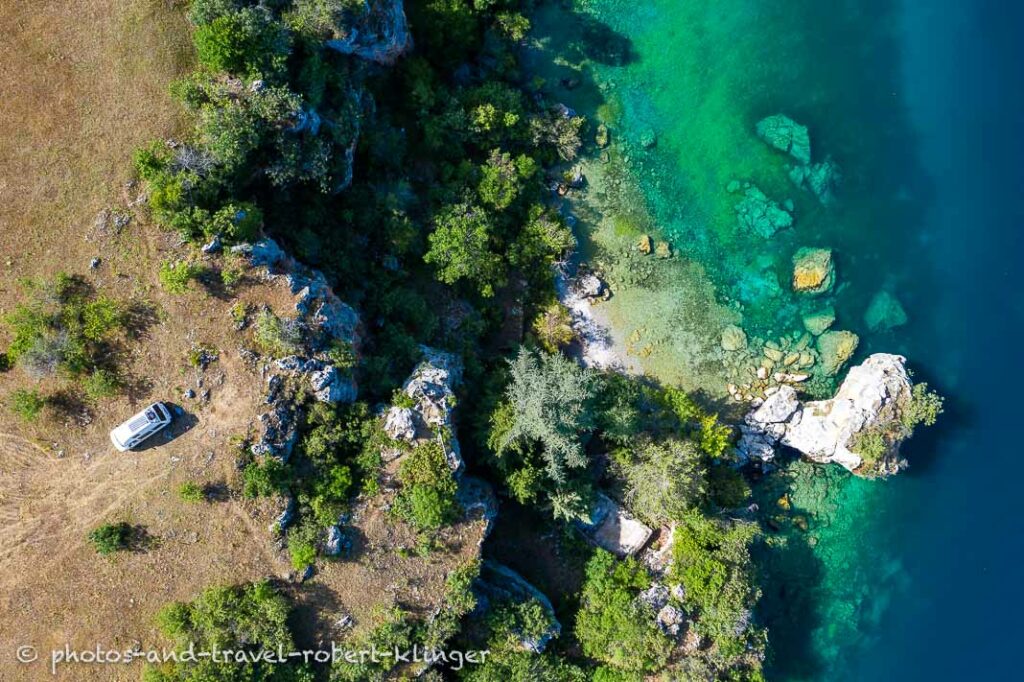 Drone photo of a VW camping van parked at lake Ohrid in Northern Macedonia