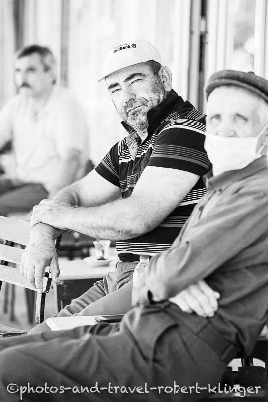 Three men sitting in front of a tearoom, Turkey