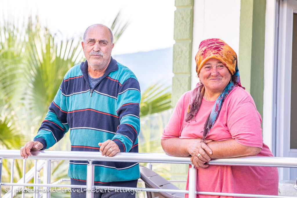 A happy old turkish couple in front of their house