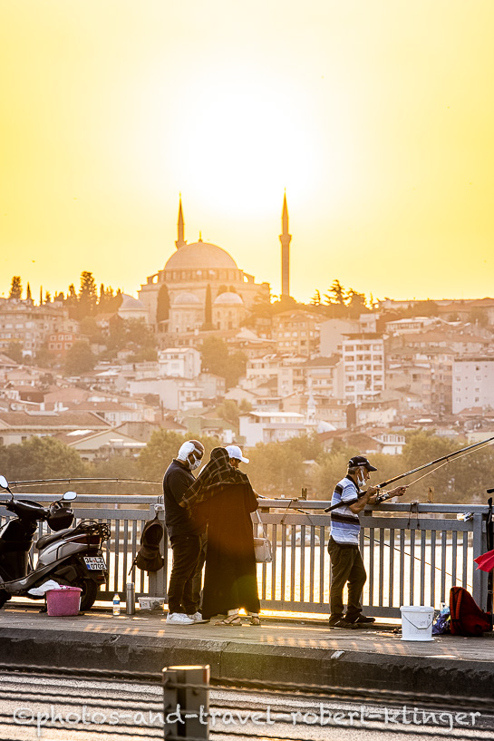 Turkish peple fishing from Atatürk-Bridge in Istanbul during sunset