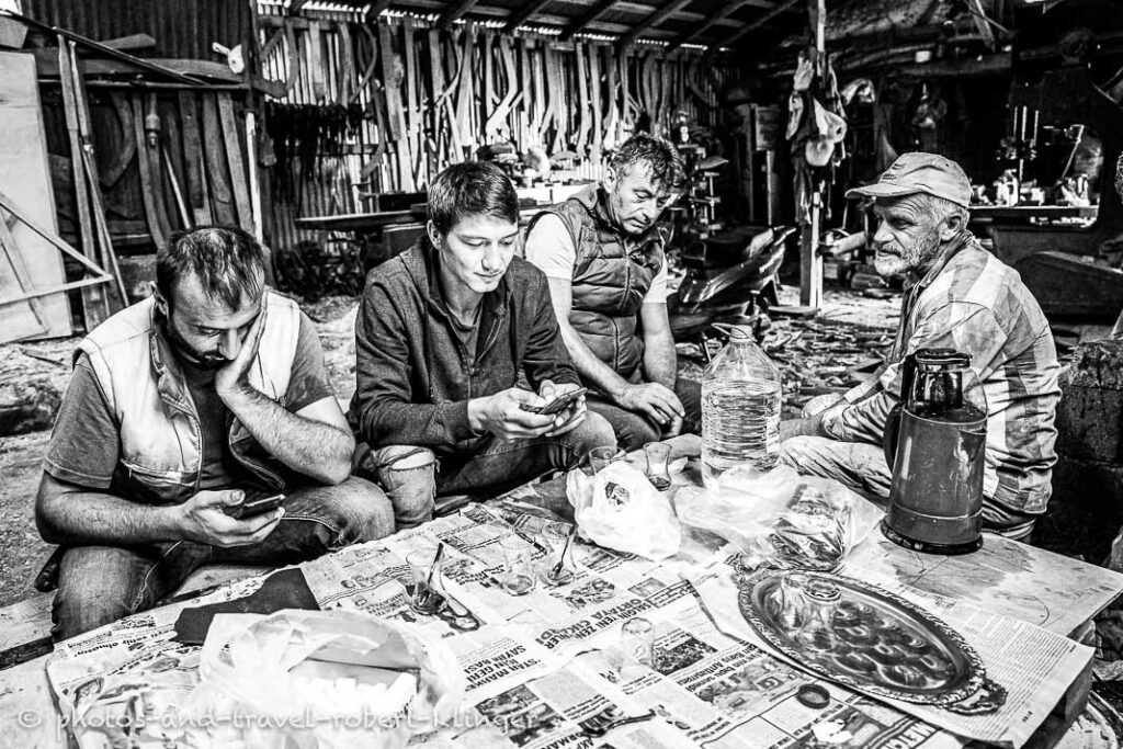 Four boat builder in Turkey having a rest in their workshop
