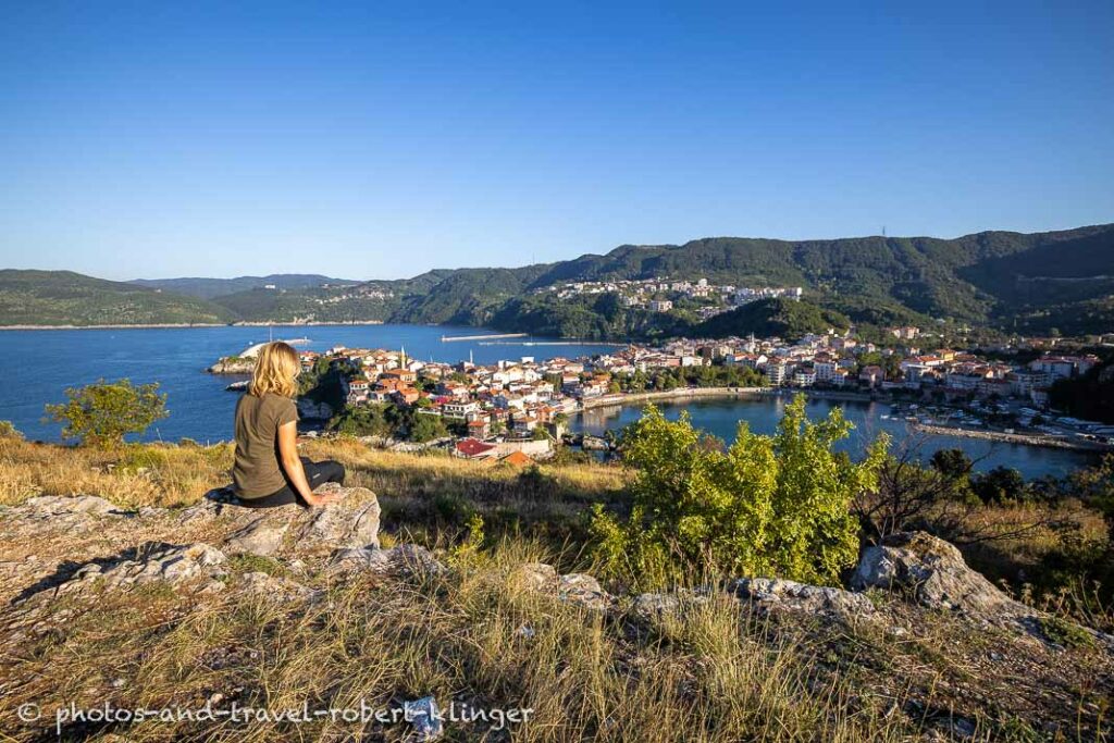 A woman sitting on a hill over Amasra, Turkey