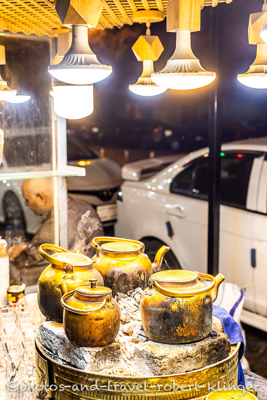 Four teapots on the fire in a street restaurant in Erbil
