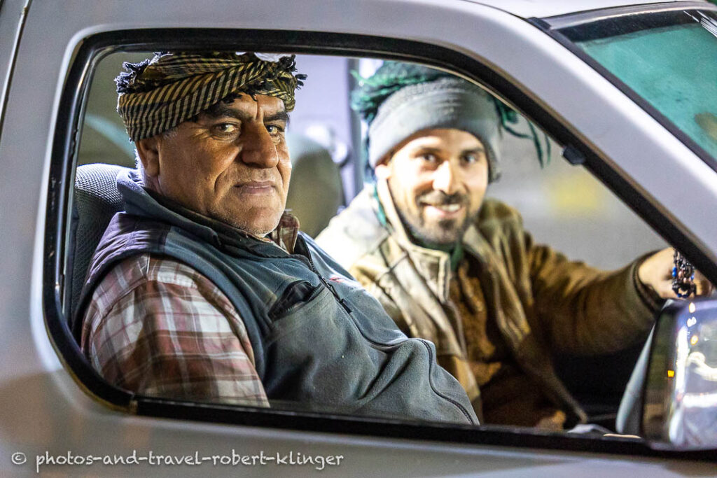 Two kurdish men sitting in a car in Kurdistane