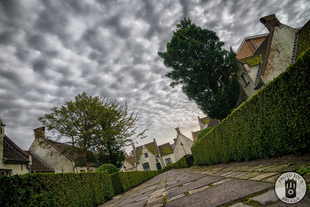 An almshouse at sunset with stunning clouds, Bruges Belgium, photo by Photo Tour Brugge.