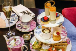 a tray of desserts and cups on a table