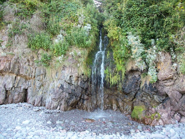 Glenthorne Beach A small waterfall cascades off the rock edge, making a pool in the pebbles below at Glenthorne beach
