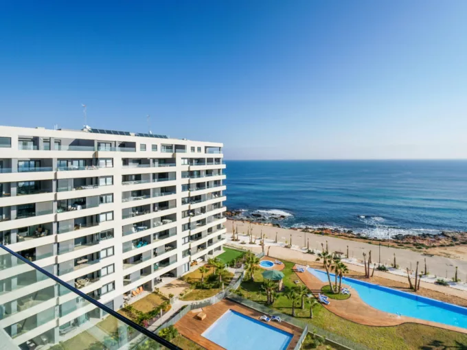 Exclusive brand new apartment with sea views in front of the beach in Punta Prima - Orihuela Costa. Property with 3 bedrooms