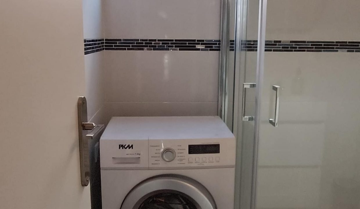 bathroom with laundry machine