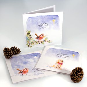 A set of three Christmas cards with robins and a puppy on looking up at the Christmas Star of David.