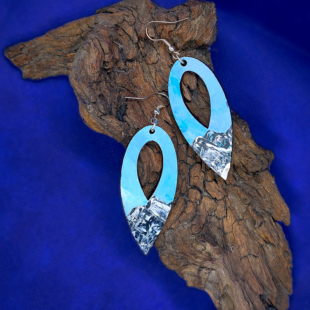 Hand painted earrings with snowy mountains.