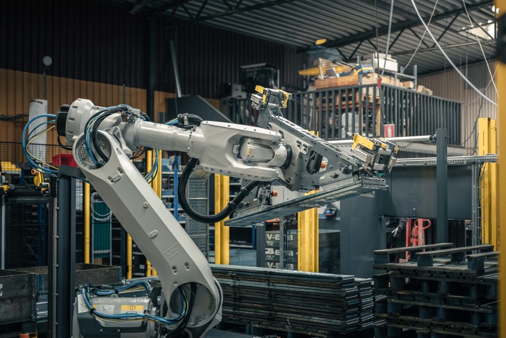 Gray robotic arm working in factory