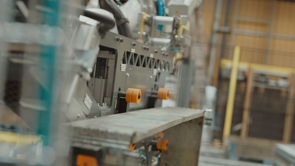 Closeup of gray robotic arm working in factory