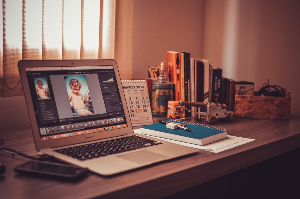 home office with a macbook and books