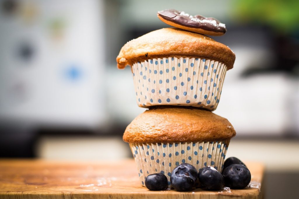 Two blueberry muffins and some berries