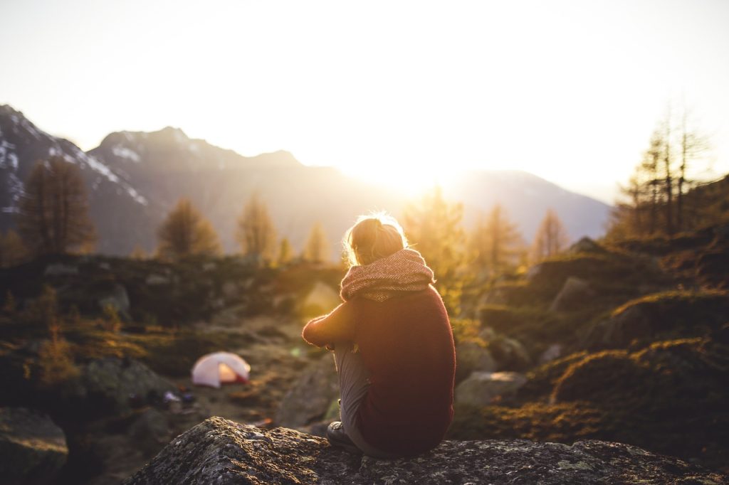 Woman watching sunset in the mountains