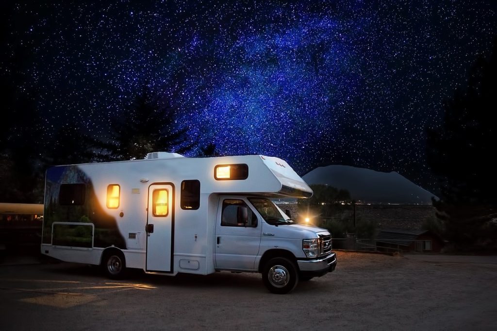 Campervan parked under a night sky