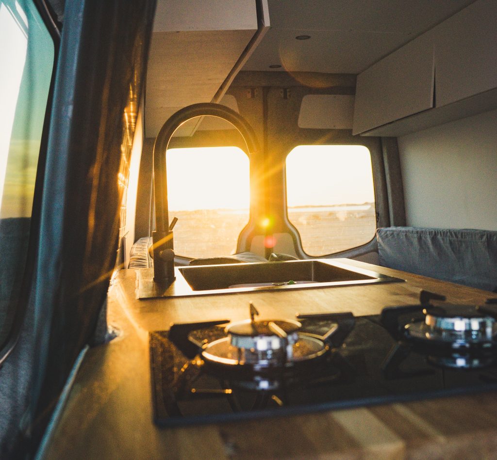 A van kitchen with a sunset view.