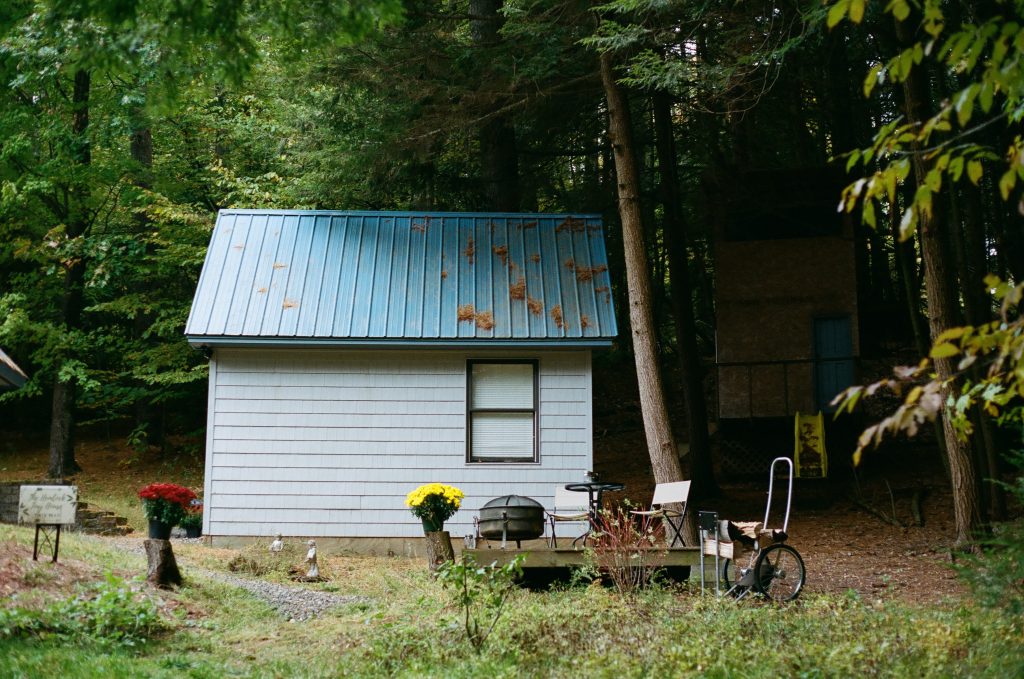 Blue tiny house in the woods