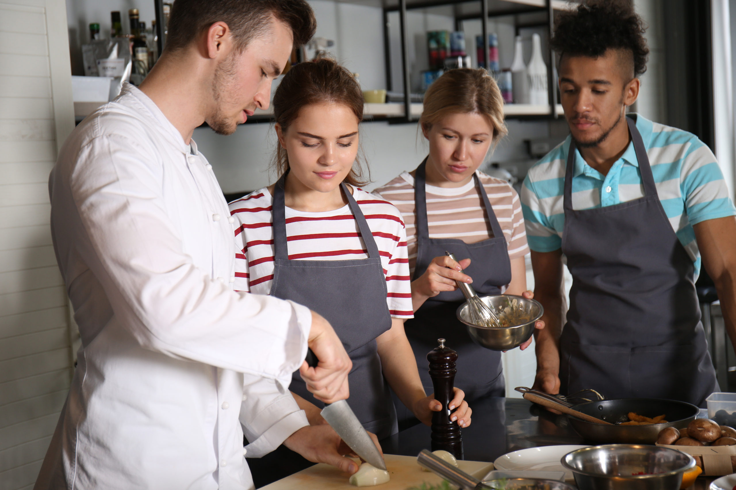 Chef and group of young people during cooking classes