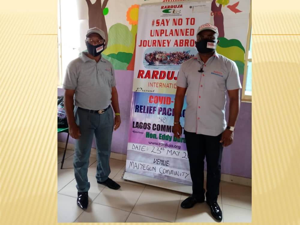 Raduja instructors with mask in front of educational seminar poster