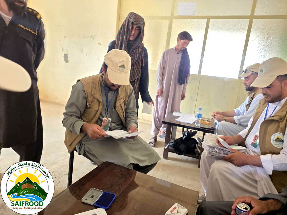 SUAO staff verify beneficiary documents before distributing emergency cash assistance to flood-affected households in Badghis Province in partnership with Rebuild Aid Forening and funded by the Danish Emergency Relief Fund (DERF).