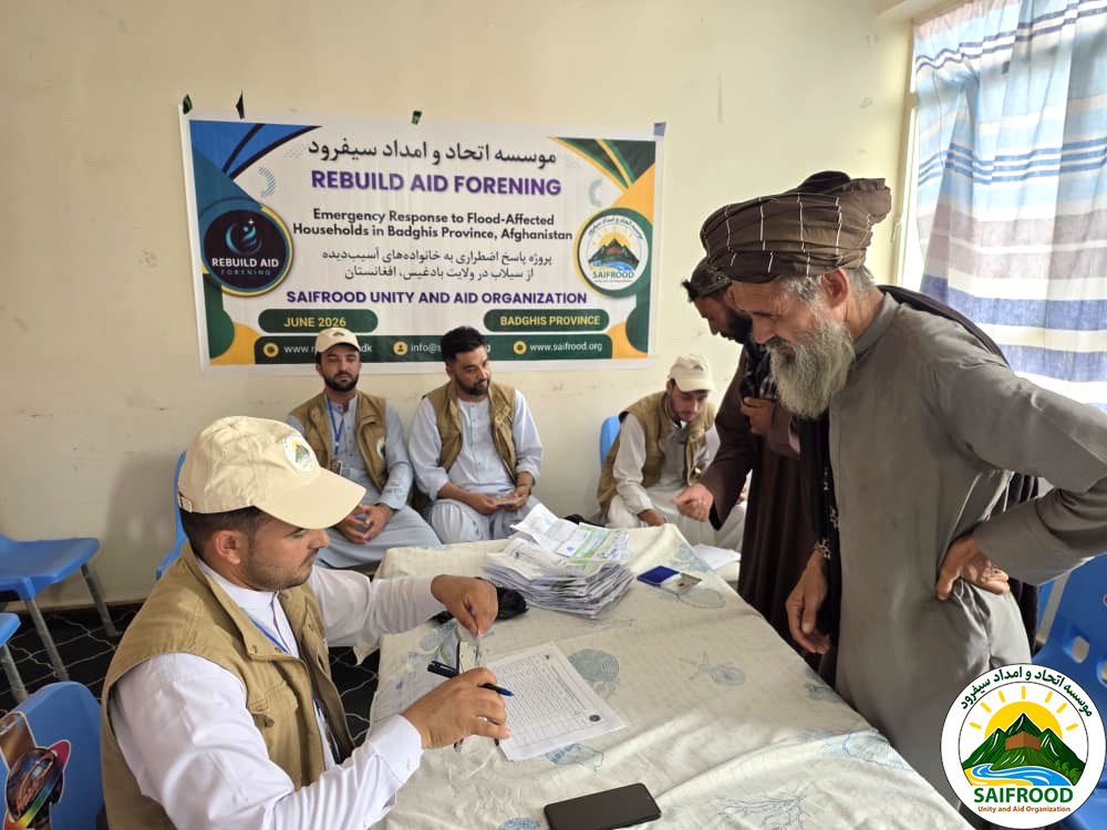 Humanitarian staff verify beneficiary identities before providing emergency cash assistance in Badghis Province.