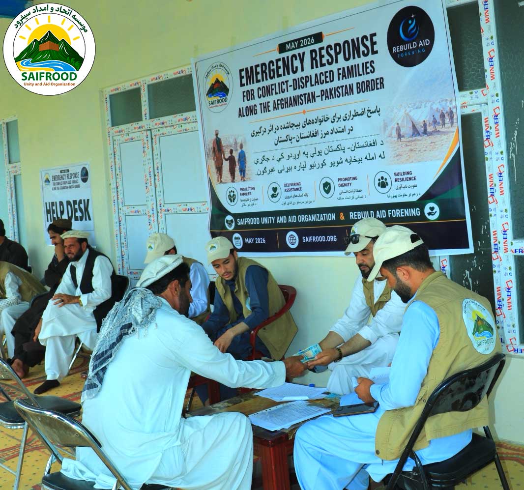 Beneficiary receiving emergency cash assistance from project staff during humanitarian distribution in Khost Province.