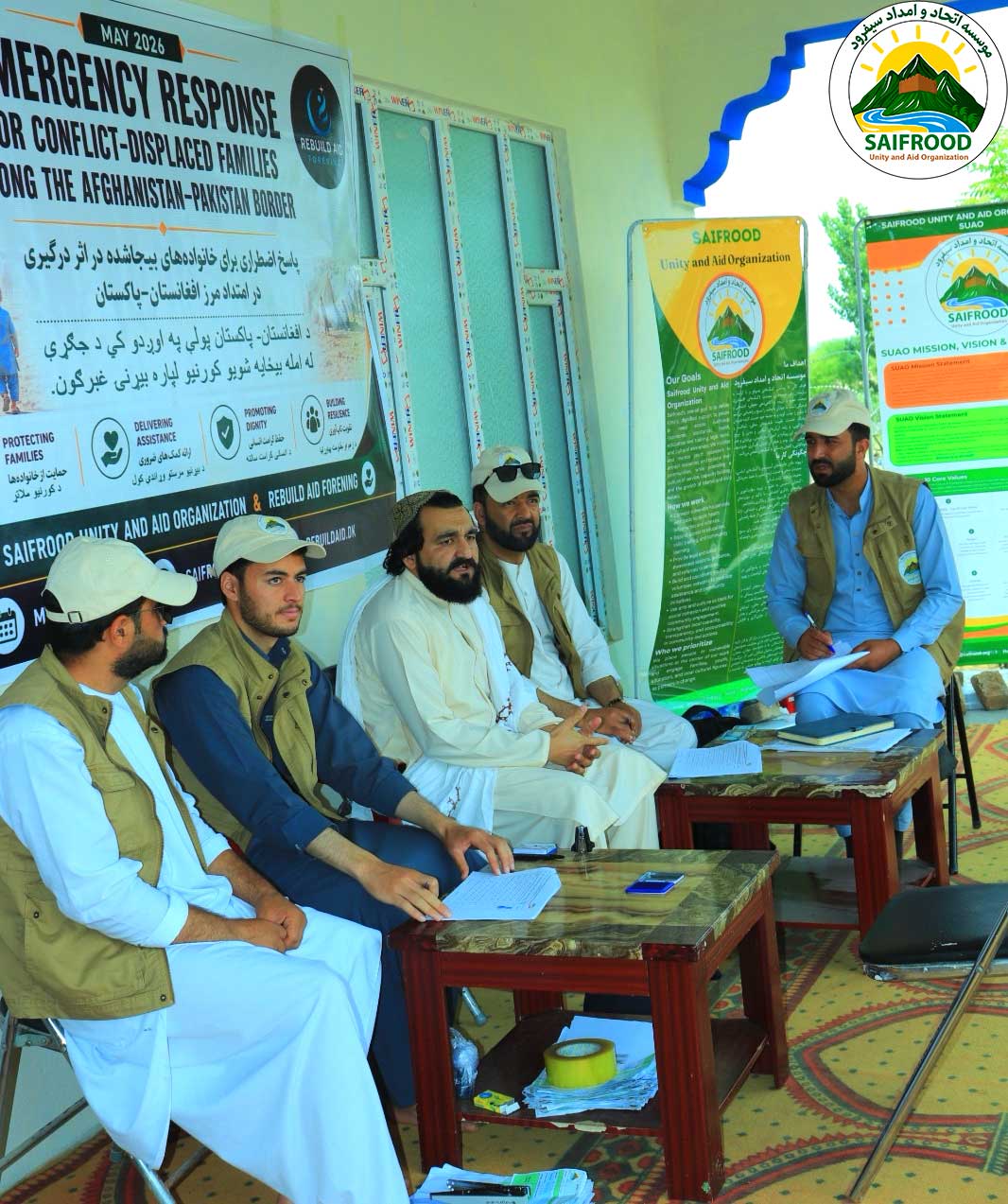 Coordination meeting between humanitarian staff and local community representatives during the emergency response project.