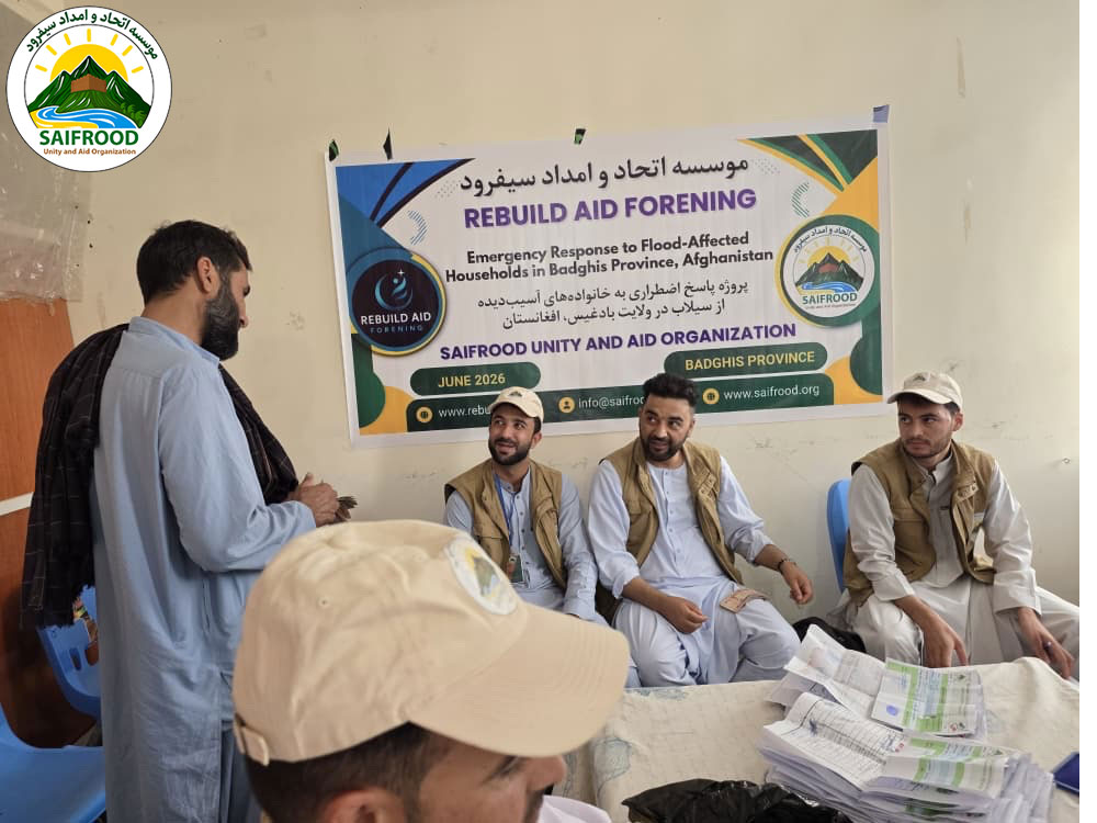 SUAO humanitarian staff consult with a beneficiary during registration for the emergency flood response project in Badghis Province.