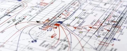 Mechanical and electrical plans laying on a table.