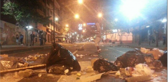 Opposition activists attempt to rebuild barricades in the wealthy neighbourhood of Chacao