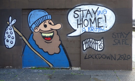 Graffiti shows homeless man with speech bubble, 'Stay home!'