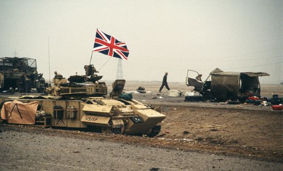 The British flag waves from an armored personnel carrier of the 7th Brigade Royal Scots as it advances along the Basra-Kuwait Highway near Kuwait City following the retreat of Iraqi forces during Operation Desert Storm (photo: public domain) The British flag waves from an armored personnel carrier of the 7th Brigade Royal Scots as it advances along the Basra-Kuwait Highway near Kuwait City following the retreat of Iraqi forces during Operation Desert Storm (photo: public domain)