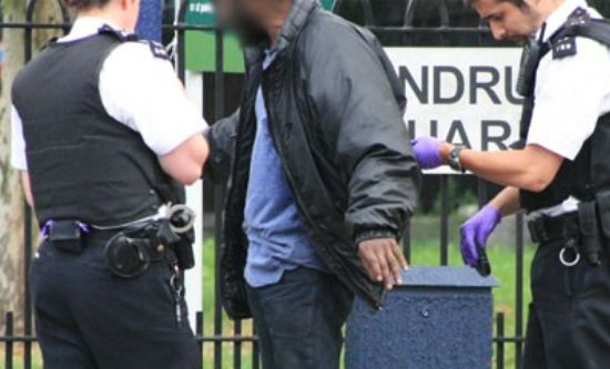 British police stop and search a black man British police stop and search a black man