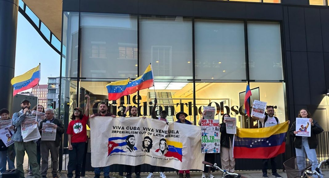 Protesters outside the London offices of the Guardian holding Venezuela flags and a banner reading 'Viva Cuba, Viva Venezuela, Imperialism out of Latin America'