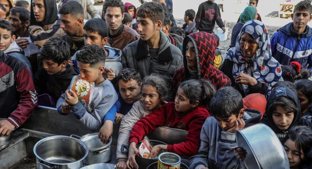 Gazans anxiously waiting for food with empty pots
