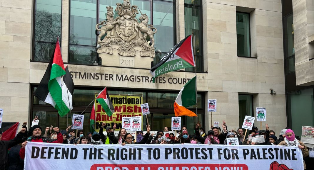 Large crowd of protesters outside Westminster Magistrates Court, London with banner reading 'Defend the right to protest for Palestine! Drop all charges now! Resistance is not terrorism!’ (photo: FRFI)