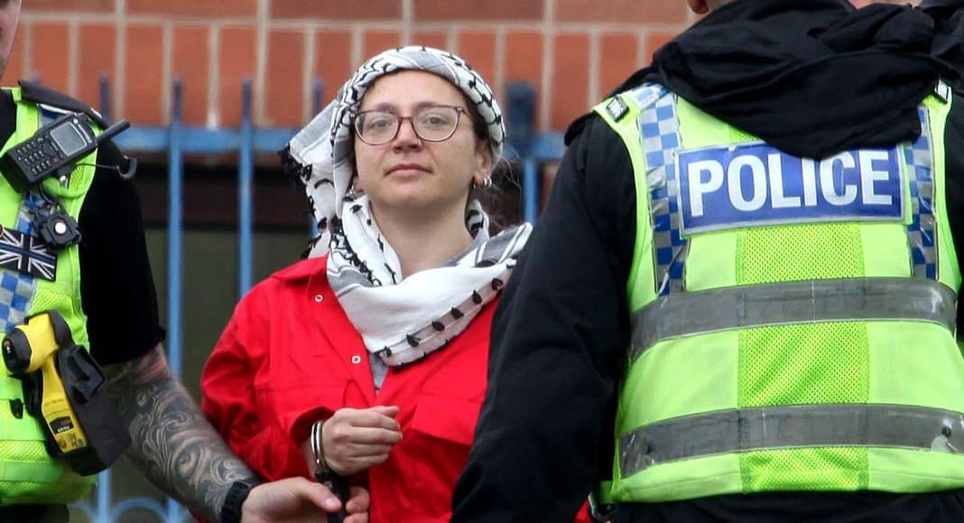 Francesca Nadin, a political prisoner with Palestine Action, is seen here being arrested after taking direct action against companies complicit in the Gaza genocide. Detained since June 2024