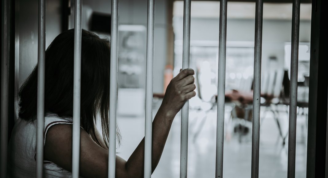 A woman behind bars