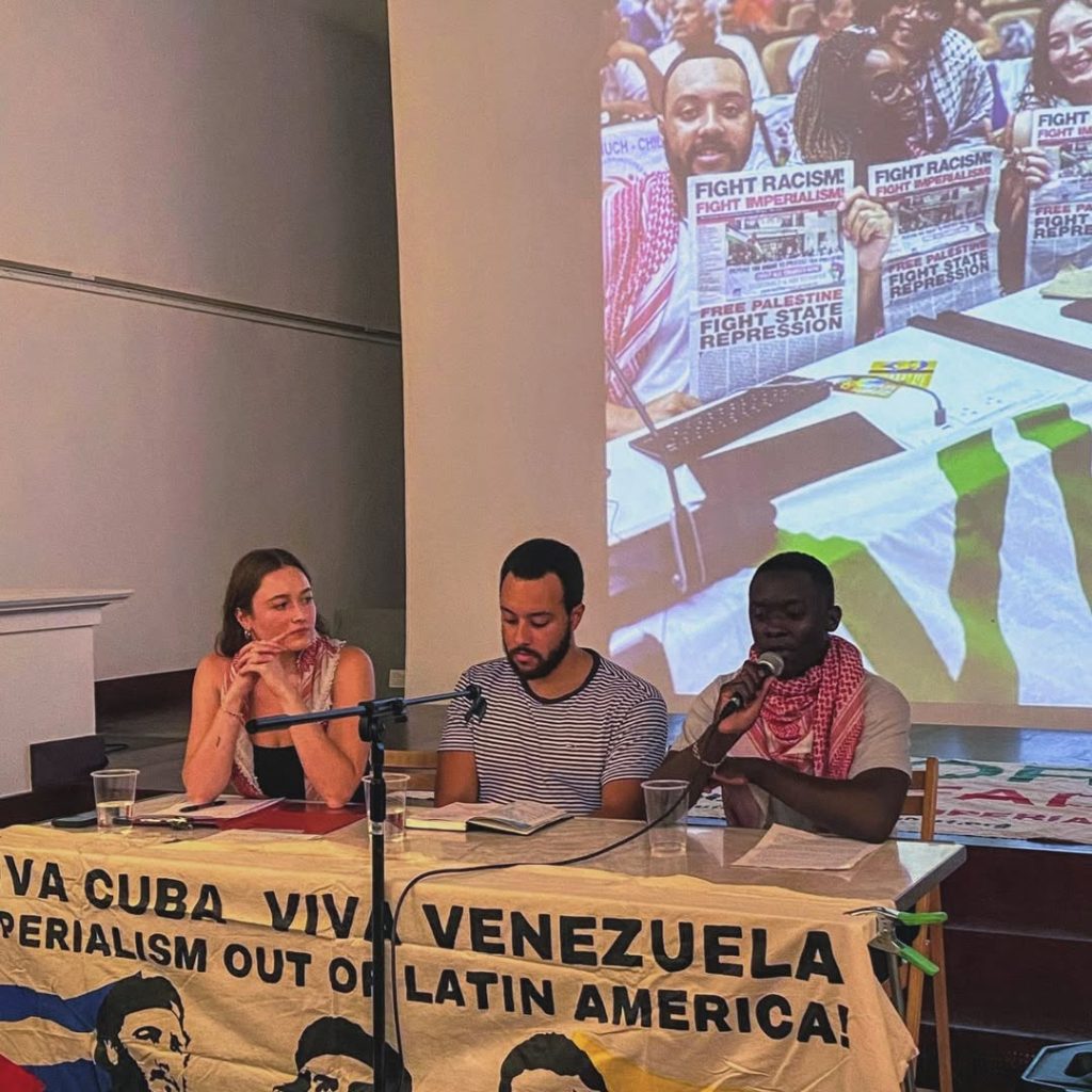 Solidarity with Cuba meeting at Bolivar Hall, 16 July 2025. The brigade members speak from the stage