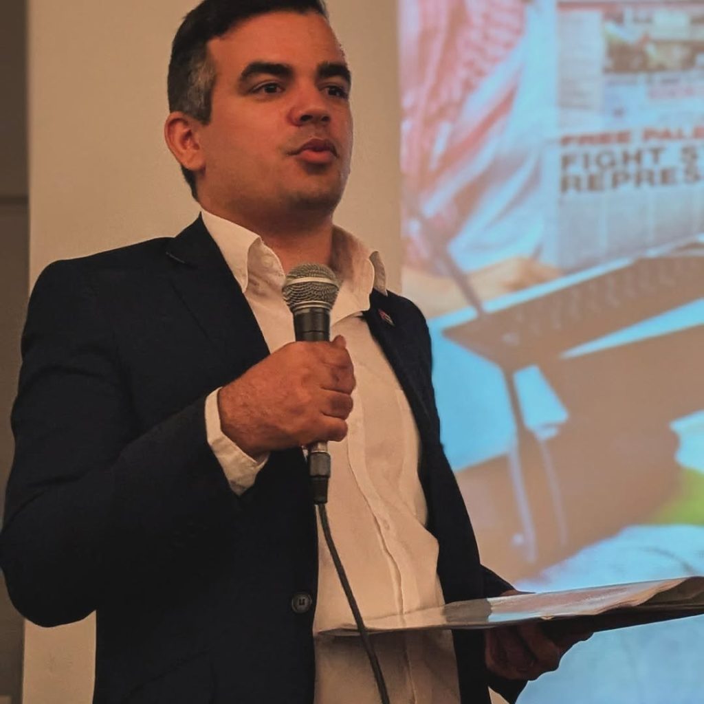 Solidarity with Cuba meeting at Bolivar Hall, 16 July 2025. Pablo Ginarte speaks from the stage