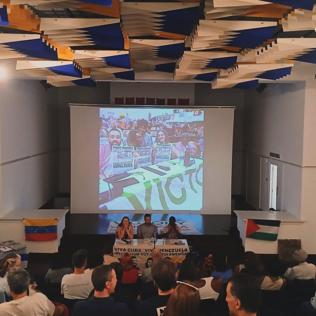 Solidarity with Cuba meeting at Bolivar Hall, 16 July 2025. A film is screened to the audience