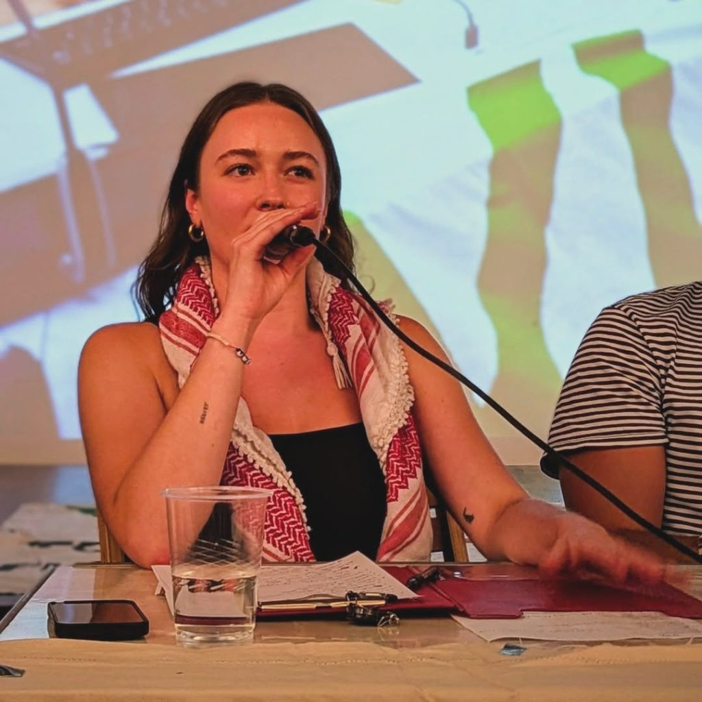 Solidarity with Cuba meeting at Bolivar Hall, 16 July 2025. Reagan Gray speaks from the stage