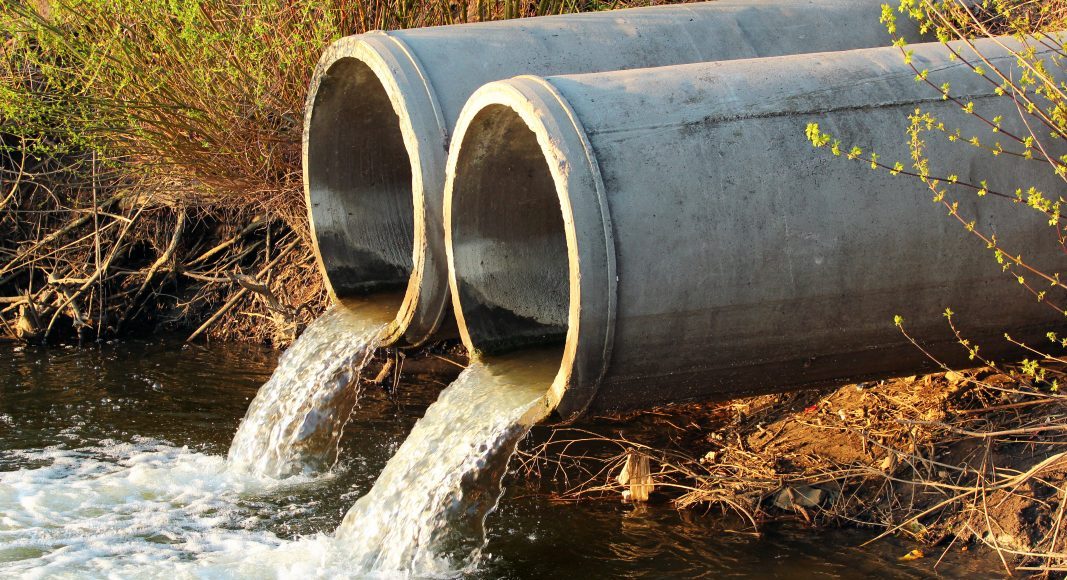Pipes discharge water into a river